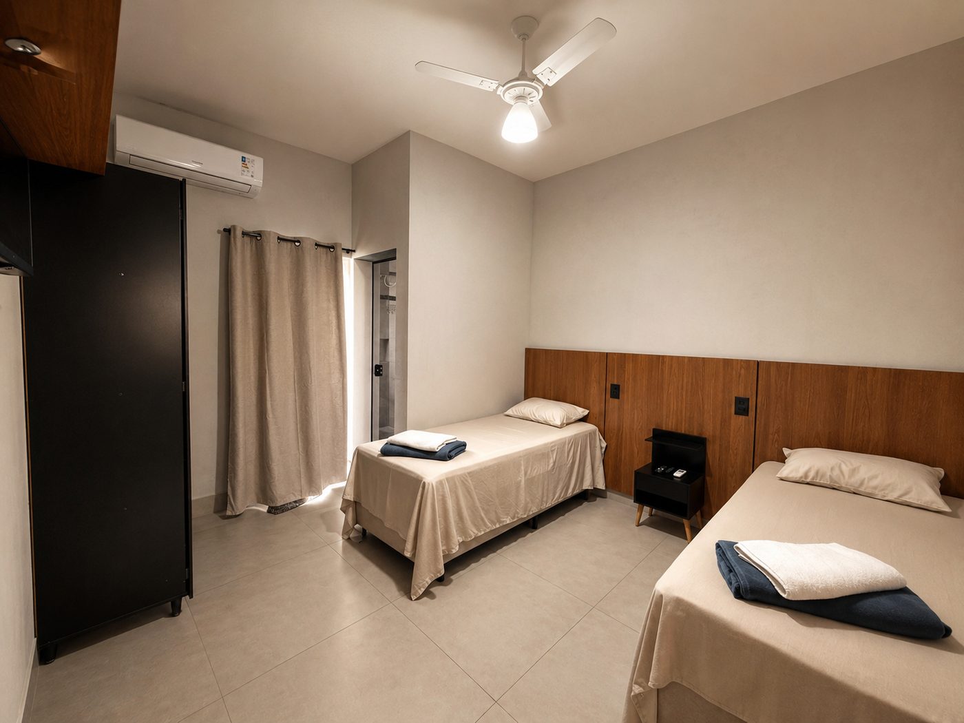 Quarto com duas camas de solteiro e guarda-roupa